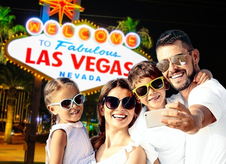 A family taking a selfie in front of the Las Vegas sign. 2
