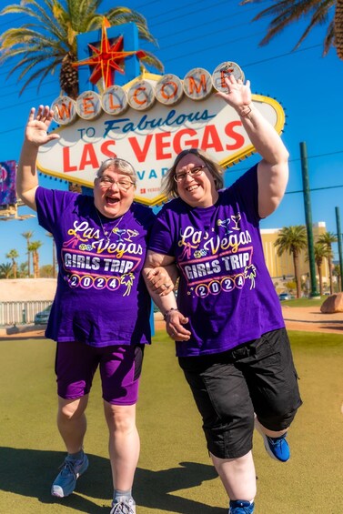 Two people holding a 'Welcome to Fabulous Las Vegas' sign. 1