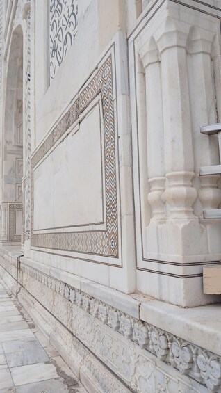 A marble facade with intricate patterns and a large rectangular void. 4