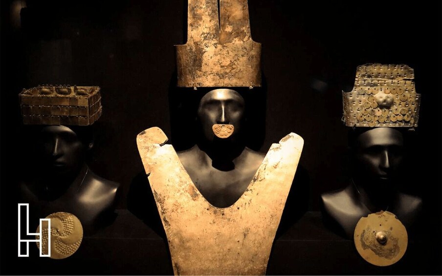Three ancient bust sculptures with distinct headdresses. 1