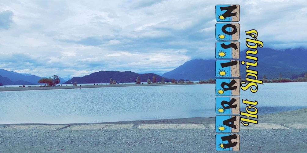 A lake with mountains in the background and a sign reading "HARRISON Hot Springs". 5