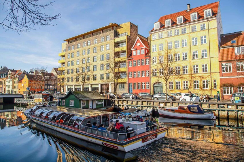 A canal with a boat, colorful buildings, and a small dock. 4