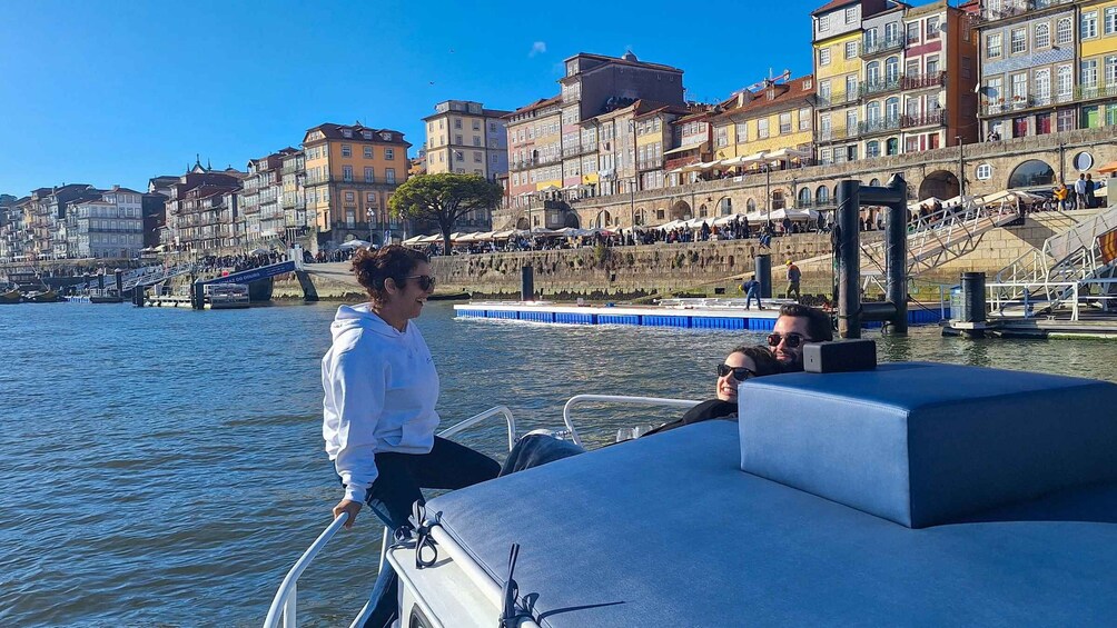 A boat on a river with a cityscape in the background. 5