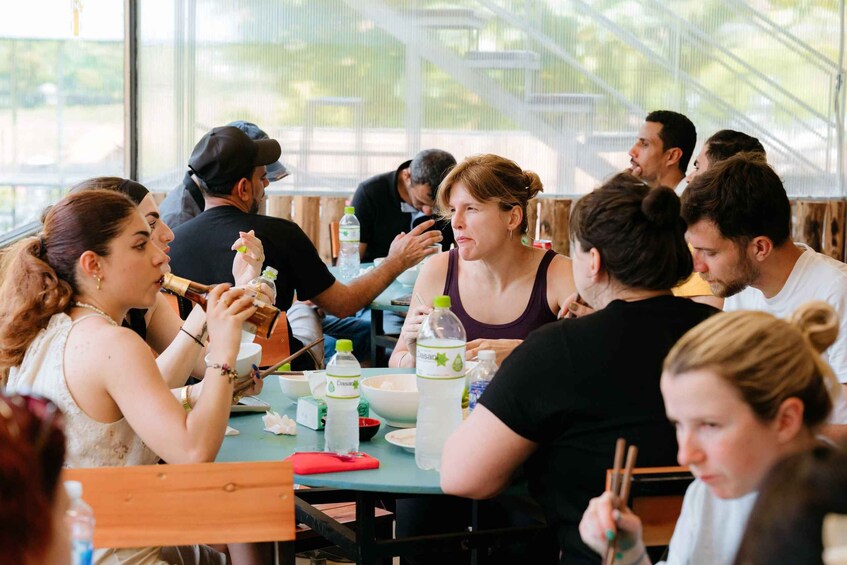 People dining at an outdoor restaurant with tables and chairs. 2