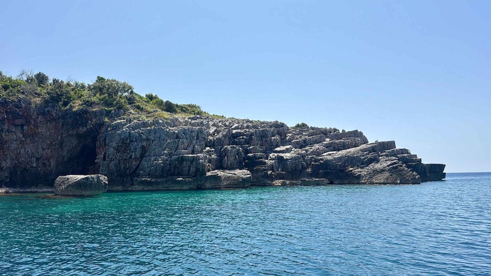 A rocky coastline with clear blue waters. 4