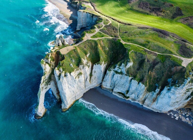 A coastal cliff with a golf course and a beach. 4