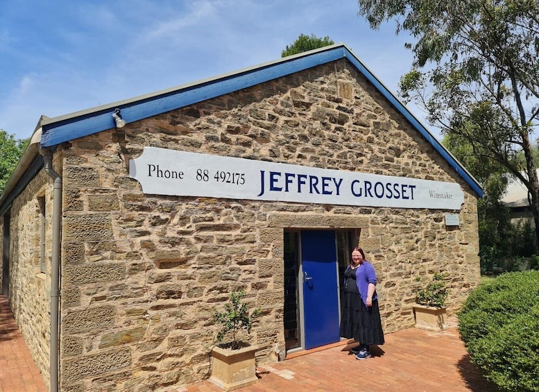 A stone building with a sign reading "JEFFREY GROSSET Winemaker" and a phone number. 2