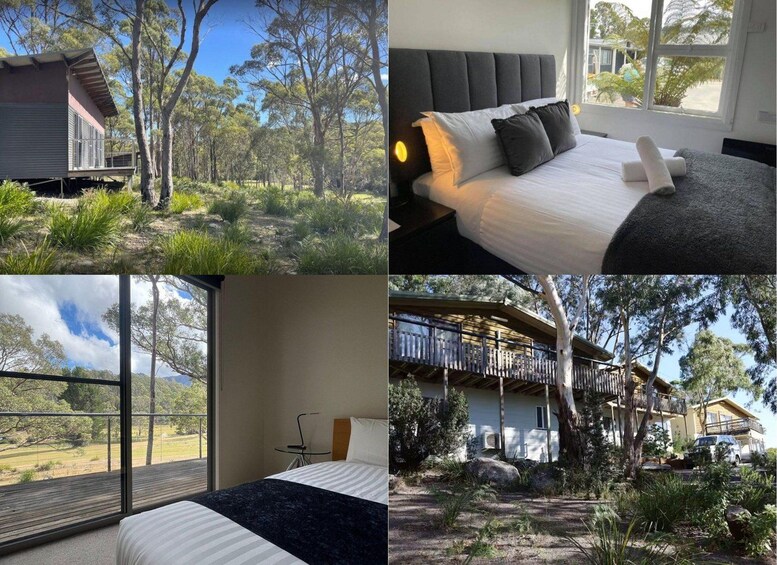 A modern bedroom with a large window, a bed with white and grey bedding, and a view of a forested area. 2