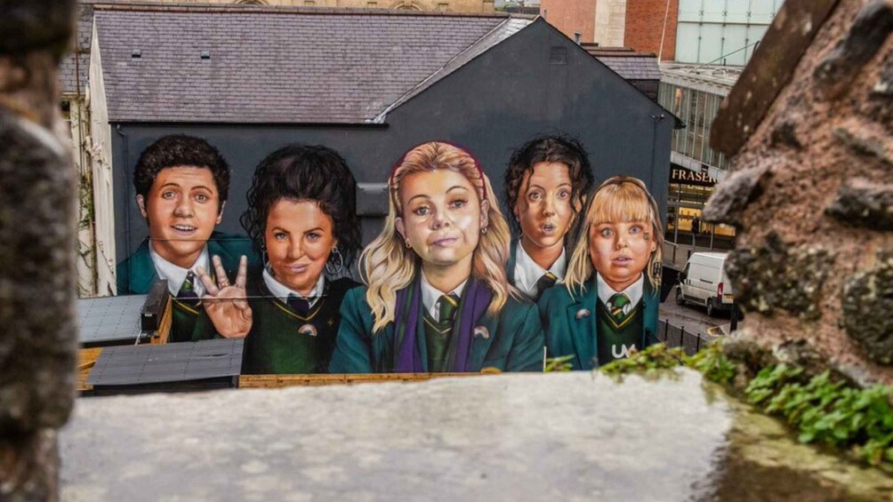 A mural of people in school uniforms on a building. 1