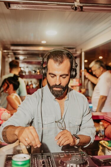 A person DJing with headphones and a mixer. 3