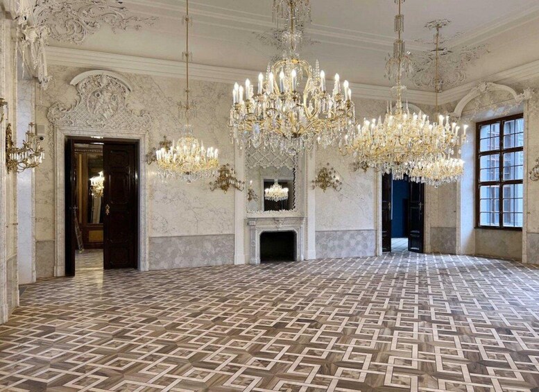 A grand hall with ornate chandeliers, marble floors, and classical architecture. 5