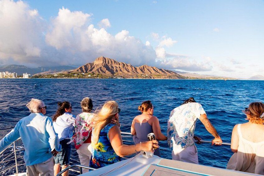 A group of people on a boat, a mountainous landscape, and a body of water. 4