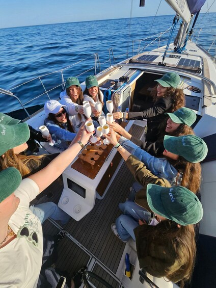 A group of people on a boat, toasting with champagne glasses. 2