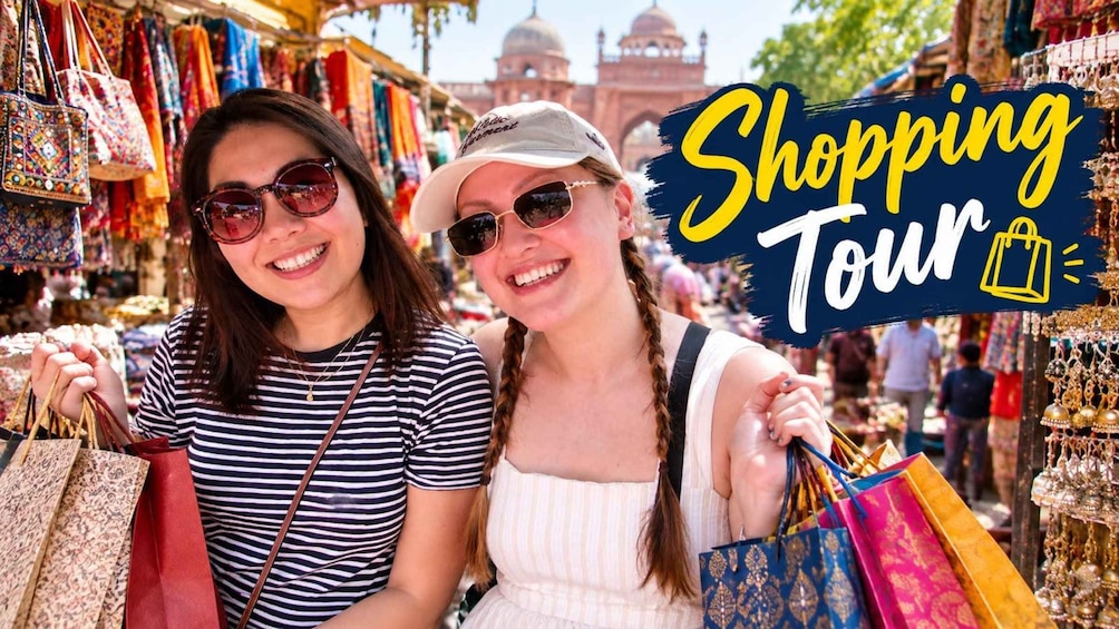 Two people shopping in a market with colorful bags and a sign that reads 'Shopping Tour'. 1