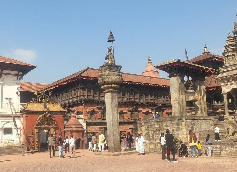 A traditional building with ornate architecture, a bell tower, and a group of people in front. 3