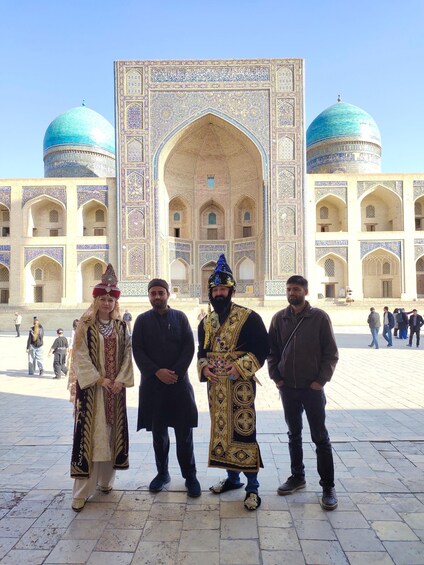 A group of people in front of a historic building with intricate tile work and domes. 3