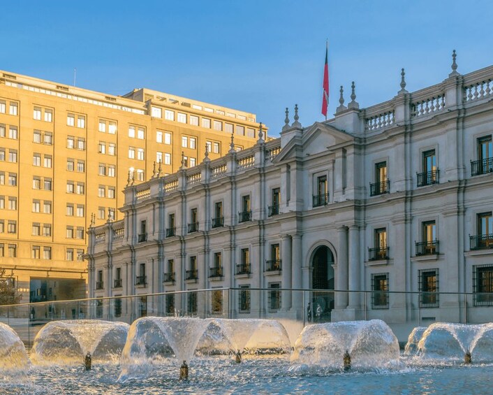 A classical building with a fountain in front. 4