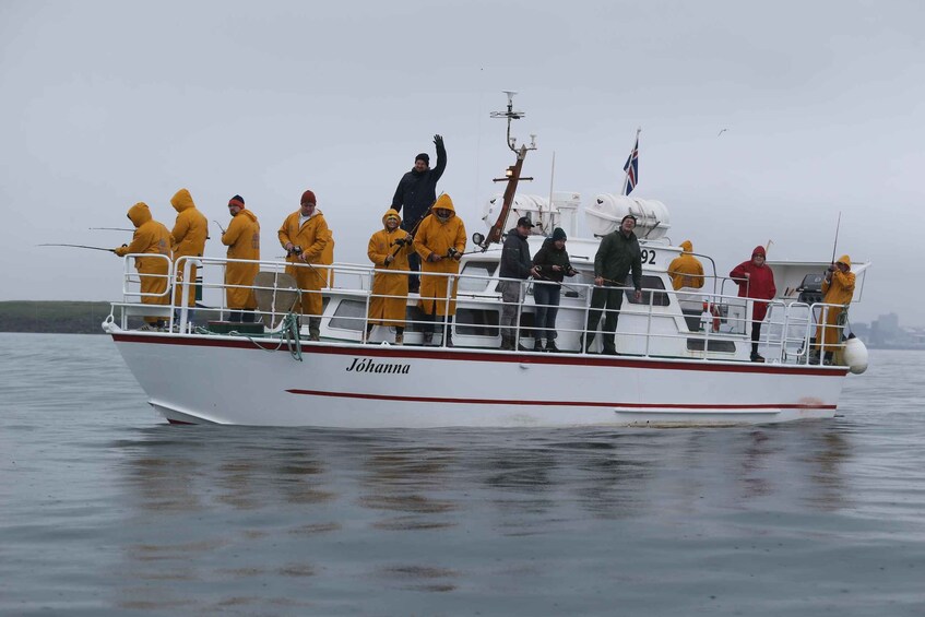 A boat named 'Johanna' with people in yellow rain gear on board, some fishing. 4