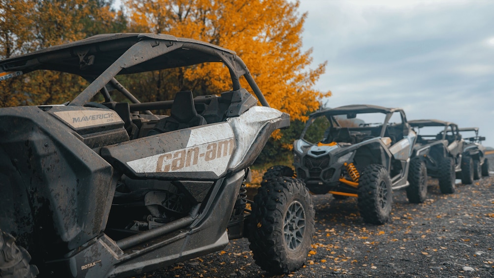 Off-road vehicles parked on a road with autumn leaves. 3
