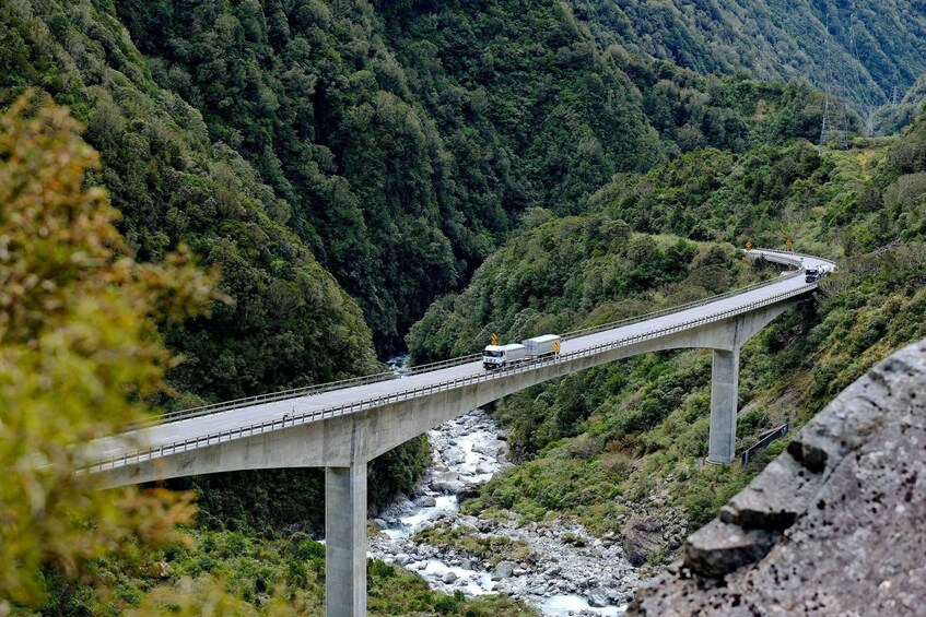 A bridge over a river in a forested valley. 5