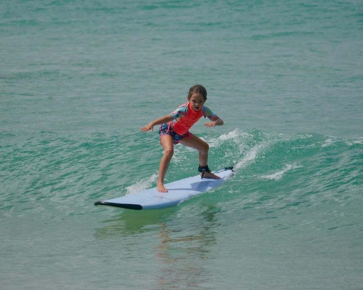 A child surfing on a wave in the ocean. 5