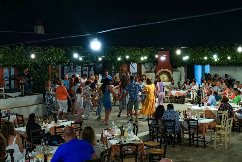 An outdoor dining area with people eating and socializing. 3