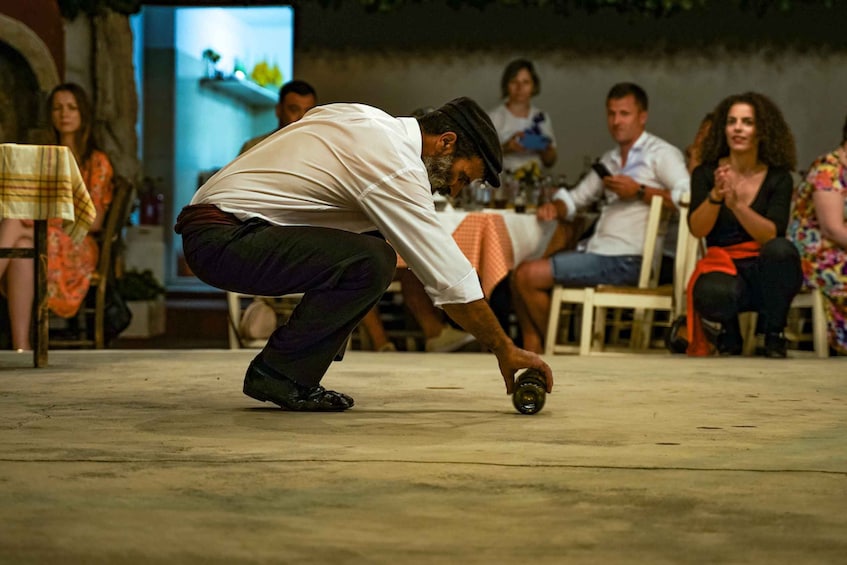A man playing a ball game on a concrete surface. 2
