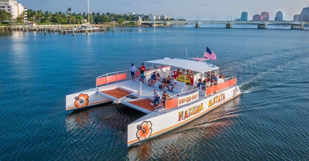 A boat with passengers, a dock, and a bridge in the background. 3