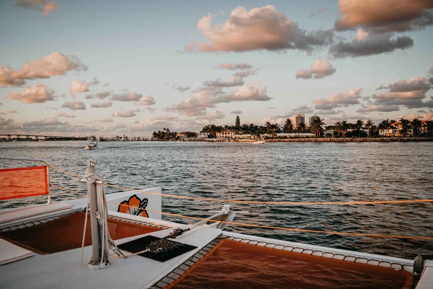 A boat deck with a view of a coastal cityscape and a bridge in the distance. 3