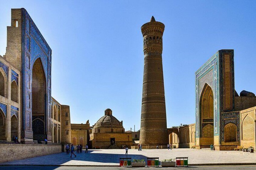 A historic building with a tall minaret, arched windows, and a dome. 3
