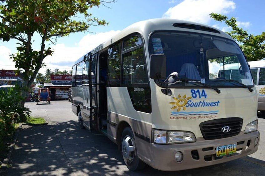 A bus with the number 814 and the name 'Southwest' on the front, parked on a street with trees and buildings in the background. 4