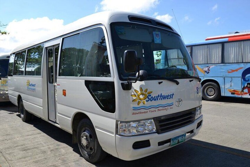 A white tour bus with 'Southwest Tours' branding parked in a lot. 3