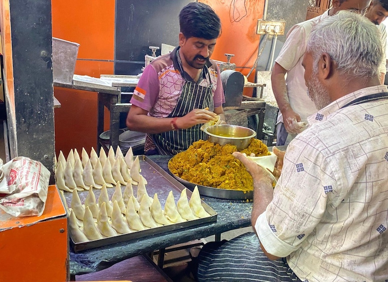 A street food vendor preparing food at a stall. 2