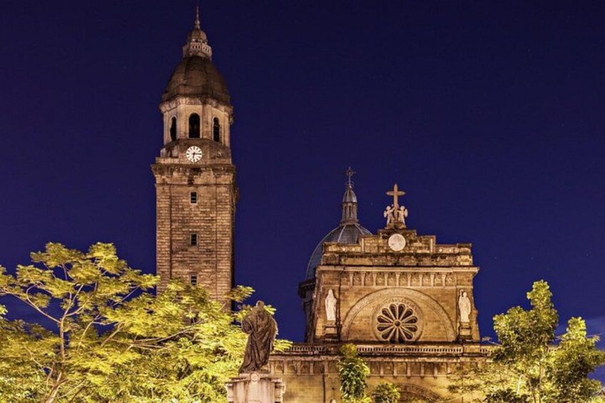 A historic building with a clock tower and a dome, surrounded by trees. 5