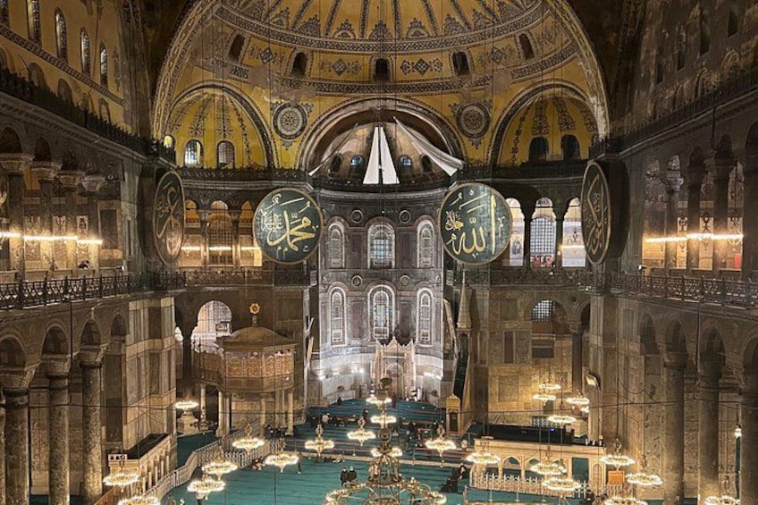 A grand interior with domed ceilings, intricate patterns, and chandeliers. 2