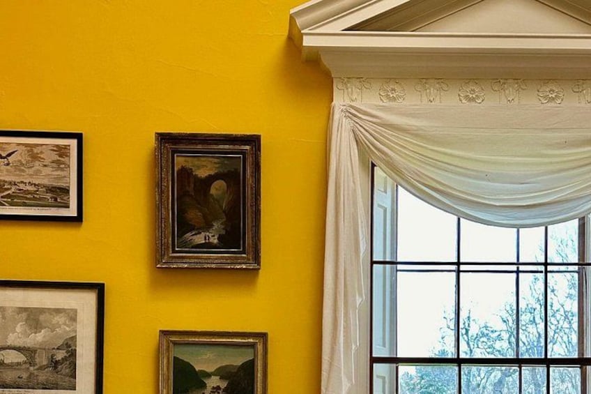 The chrome yellow walls of the dining room display a portrait of Natural Bridge that Thomas Jefferson once owned 3