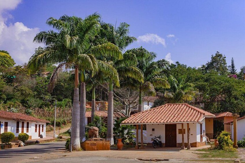 A residential area with houses, palm trees, and a clear sky. 5