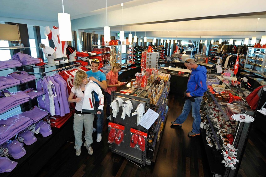 A retail store with shelves of clothing and accessories, including hats and gloves. 5