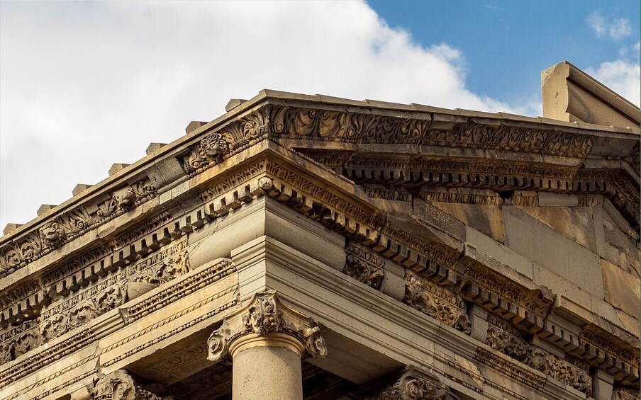 A detailed stone structure with ornate carvings and columns. 4