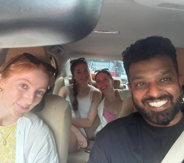 Three people seated in a car interior. 5