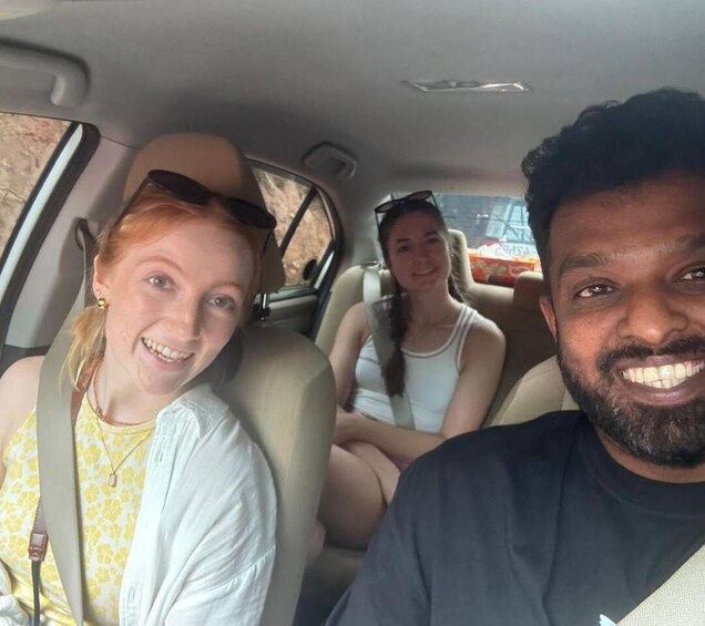 Three people seated in a car with beige interior. 4