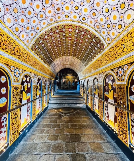 A corridor with ornate floral patterns on the walls and ceiling, leading to a central area. 2