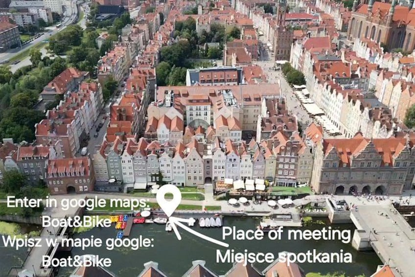 A historic European town with narrow streets, traditional buildings, and a river. 4
