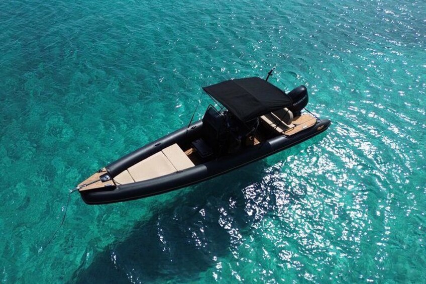 A small motorboat on clear turquoise water. 2