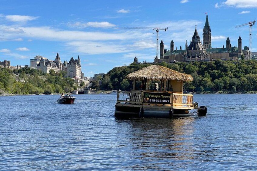 A river with a floating structure, a boat, and a castle in the background. 2
