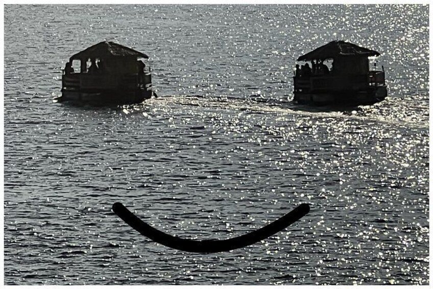 Two wooden houses on water, a curved structure, and a boat. 3