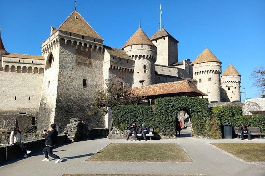 A historic castle with multiple towers and a paved courtyard. 2