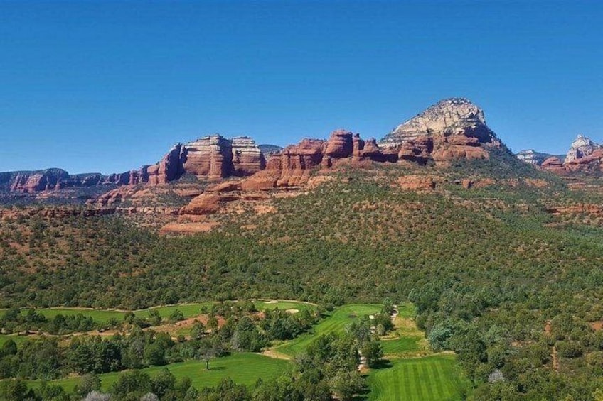 A mountainous landscape with a golf course. 1