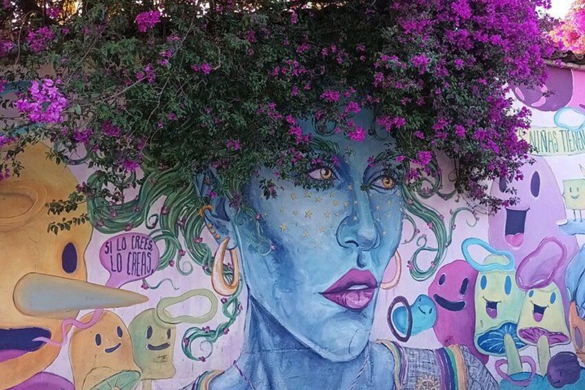 A colorful mural with abstract figures and text. 3