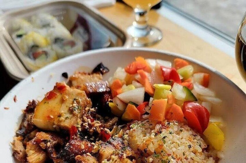 A meal with grilled chicken, a side of diced vegetables, and a glass of wine. 1
